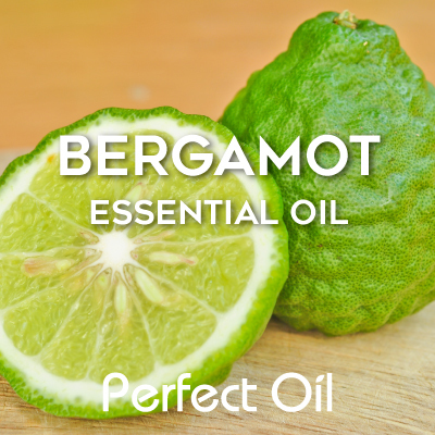 Picture showing two halves of a bergamot with the half on the left facing forward and slightly upward and the half on the right facing downward and somewhat behind the other half. The words bergamot essential oil and Perfect Oil in white are on top of the image itself. 