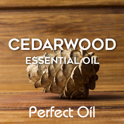 Picture showing a cedarwood code on a wooden surface with the words cedarwood essential oil and Perfect Oil in white on top of the image itself. 