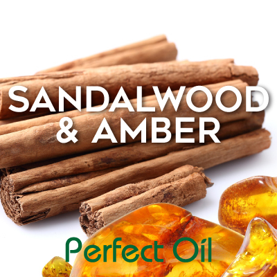 Picture showing a stack of sandalwood sticks above a handful of amber stones with the words sandalwood &amp; amber in white and Perfect Oil in green on top of the image itself. 
