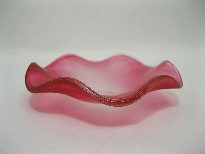 Picture of a frosted red wavy glass replacement bowl for an aroma night light. 