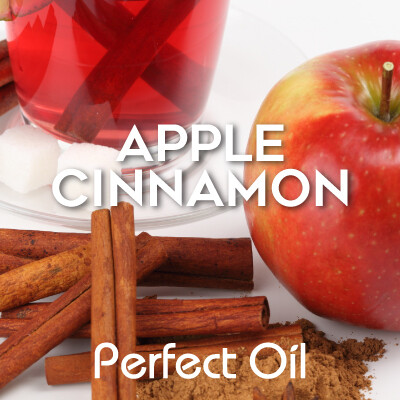 Picture showing an apple with several cinnamons sticks and a glass cup of tea with sugar cubes on a glass plate with the words apple cinnamon and Perfect Oil in white on top of the picture. 