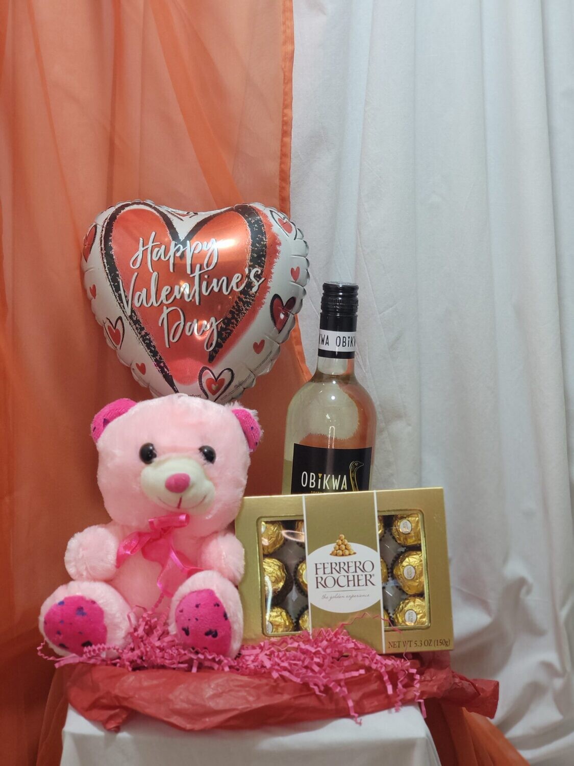 Medium Teddy, Wine, Chocolates and a balloon