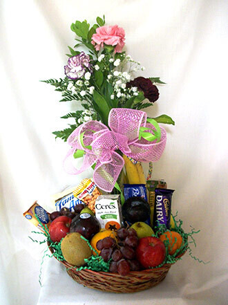 Fruit basket with 3 Carnations in a vase