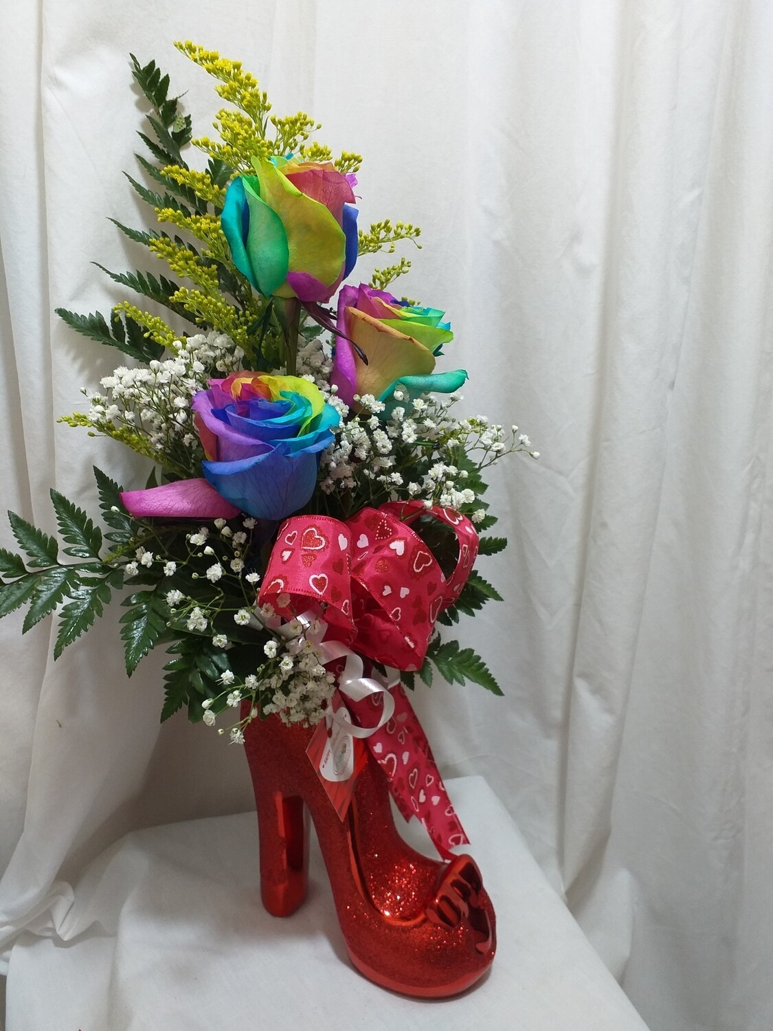 3 Rainbow roses in a red shoe vase 