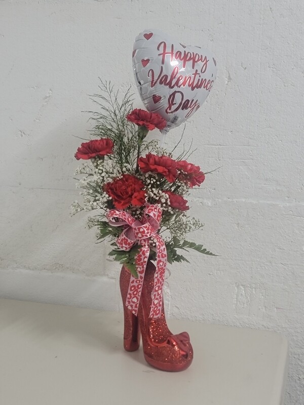 6 carnations and a balloon in a shoe vase