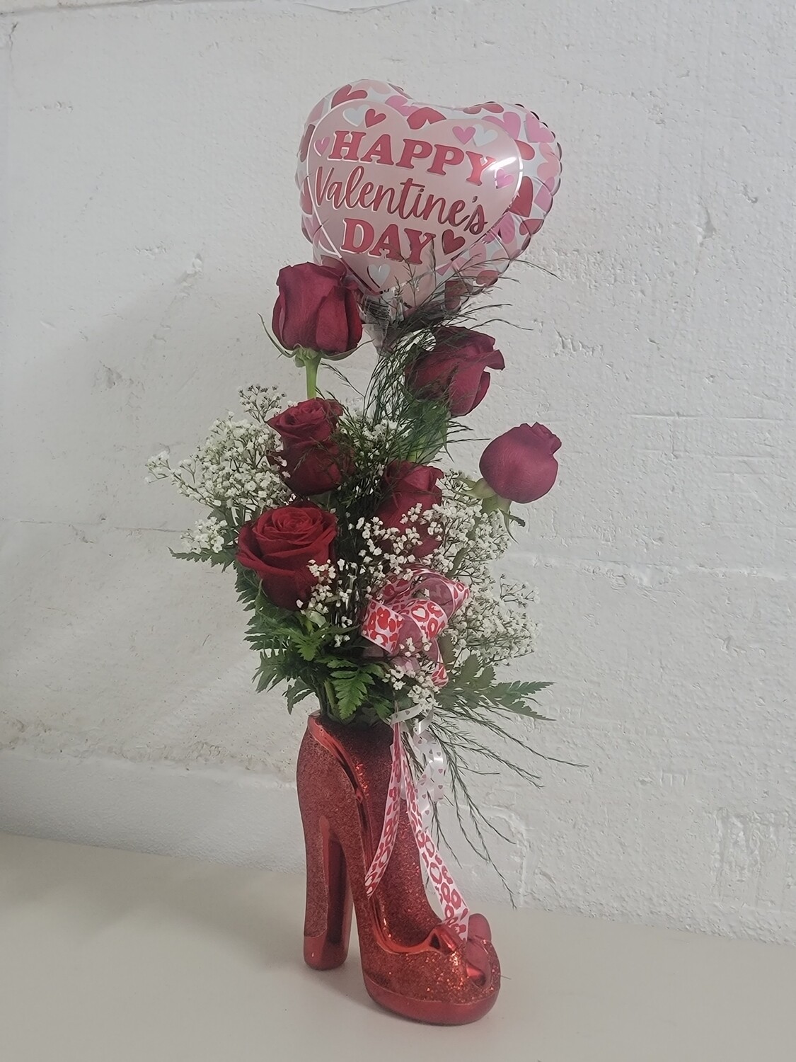 6 roses and a balloon in a red shoe vase