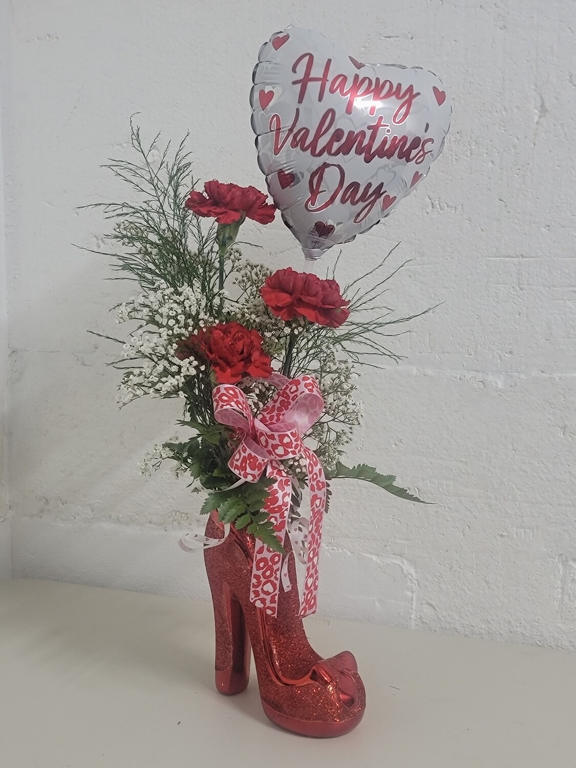 3 Carnations and a balloon in a shoe vase