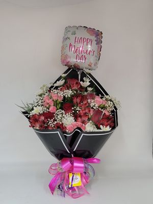 Cut flowers in a black wrap with a balloon