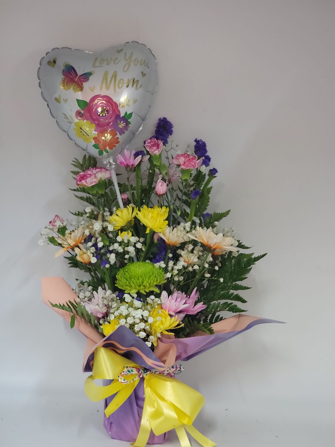 Cut flowers in a wrap with a balloon