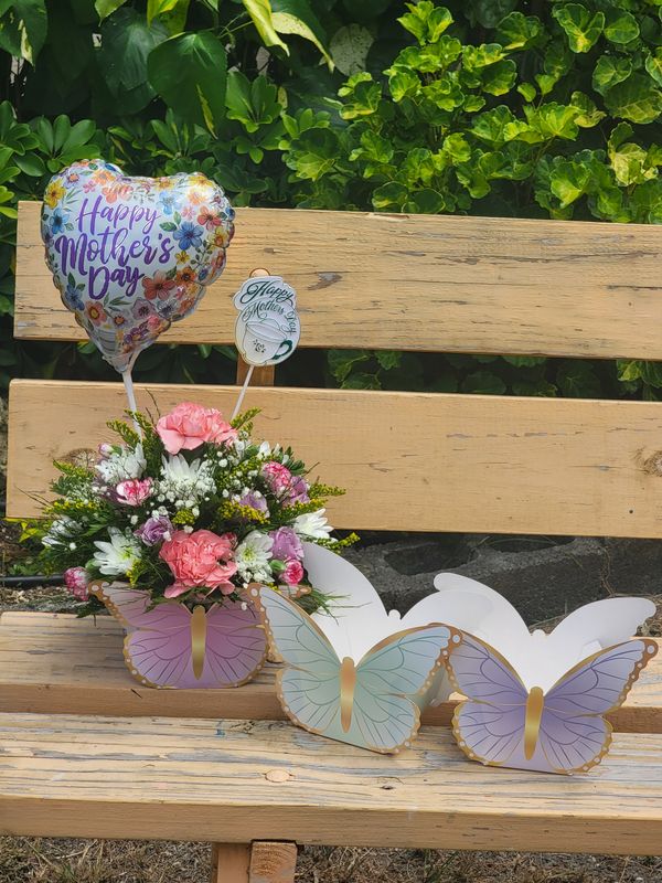 Cut flowers in a butterfly box with a balloon