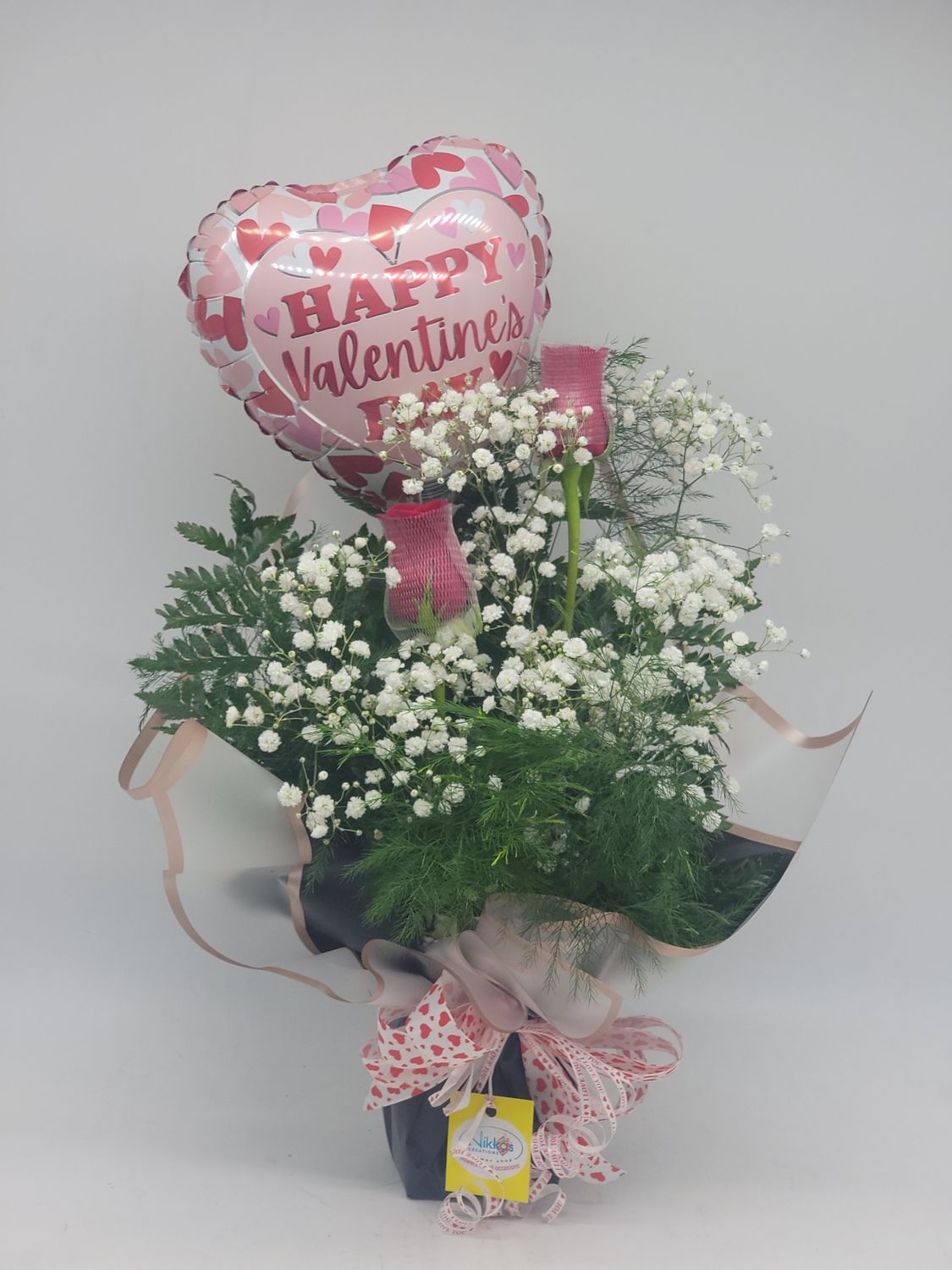 Valentines 2 roses in a wrap with a balloon