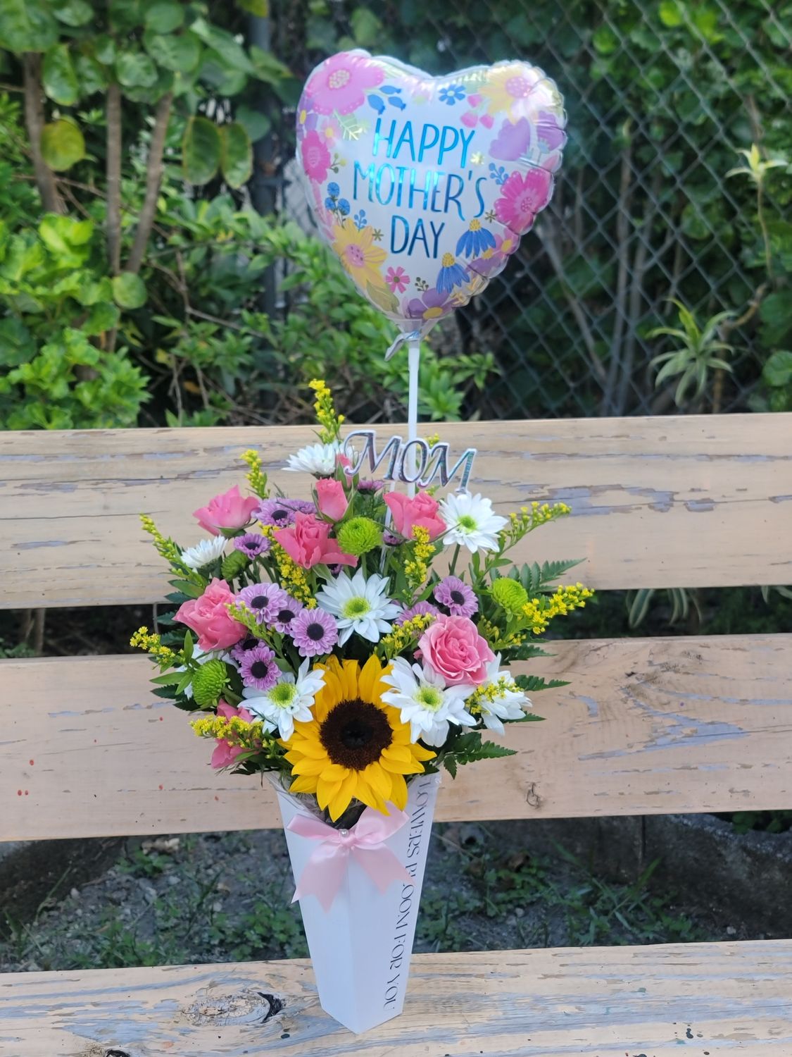 Cut flowers in a box with a balloon