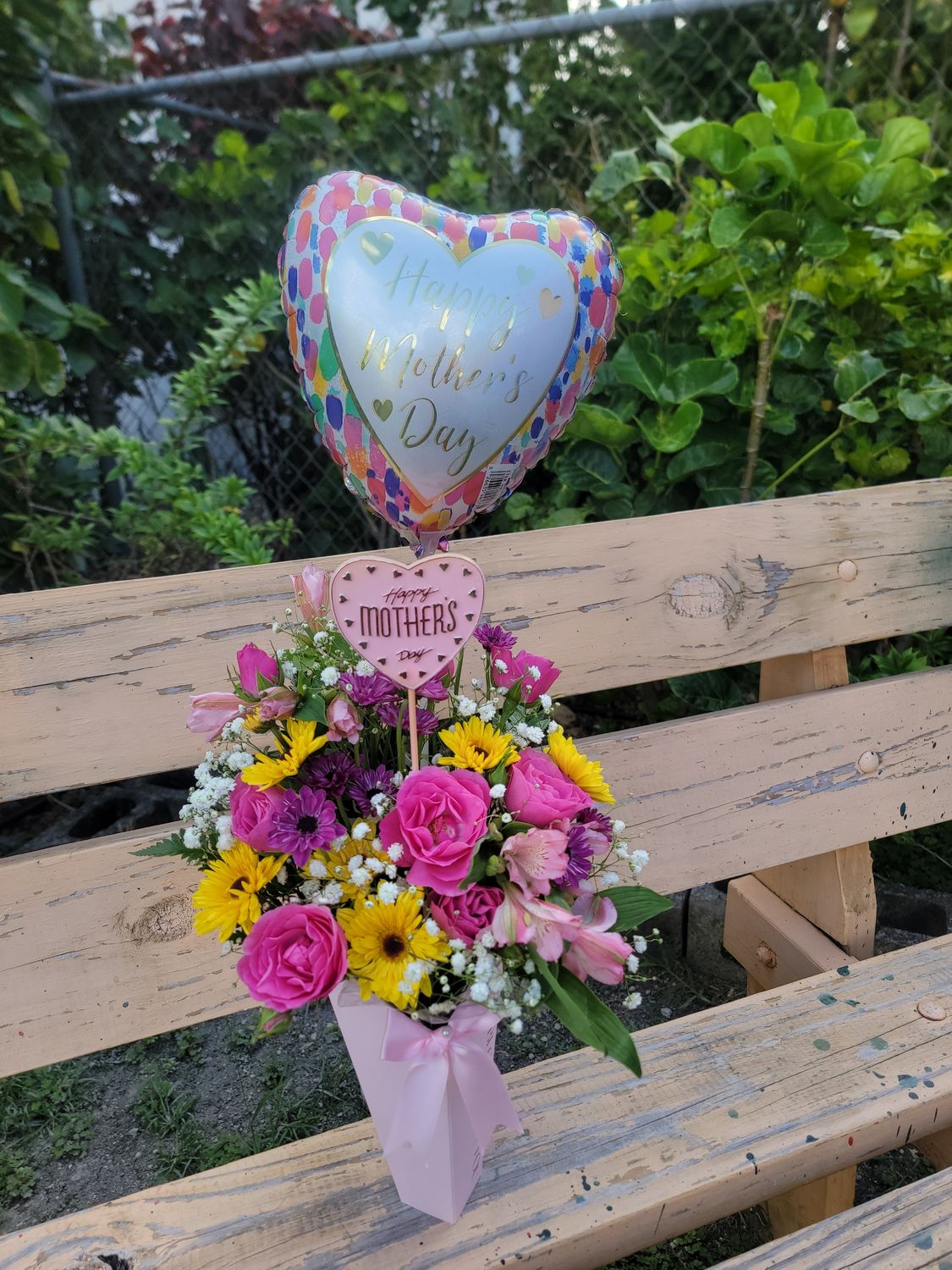 Cut flower in a box with a balloon