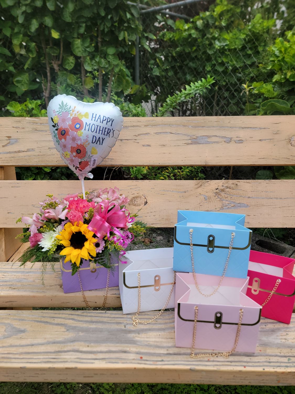 Cut flowers in a Hand bag with chain and ballloon