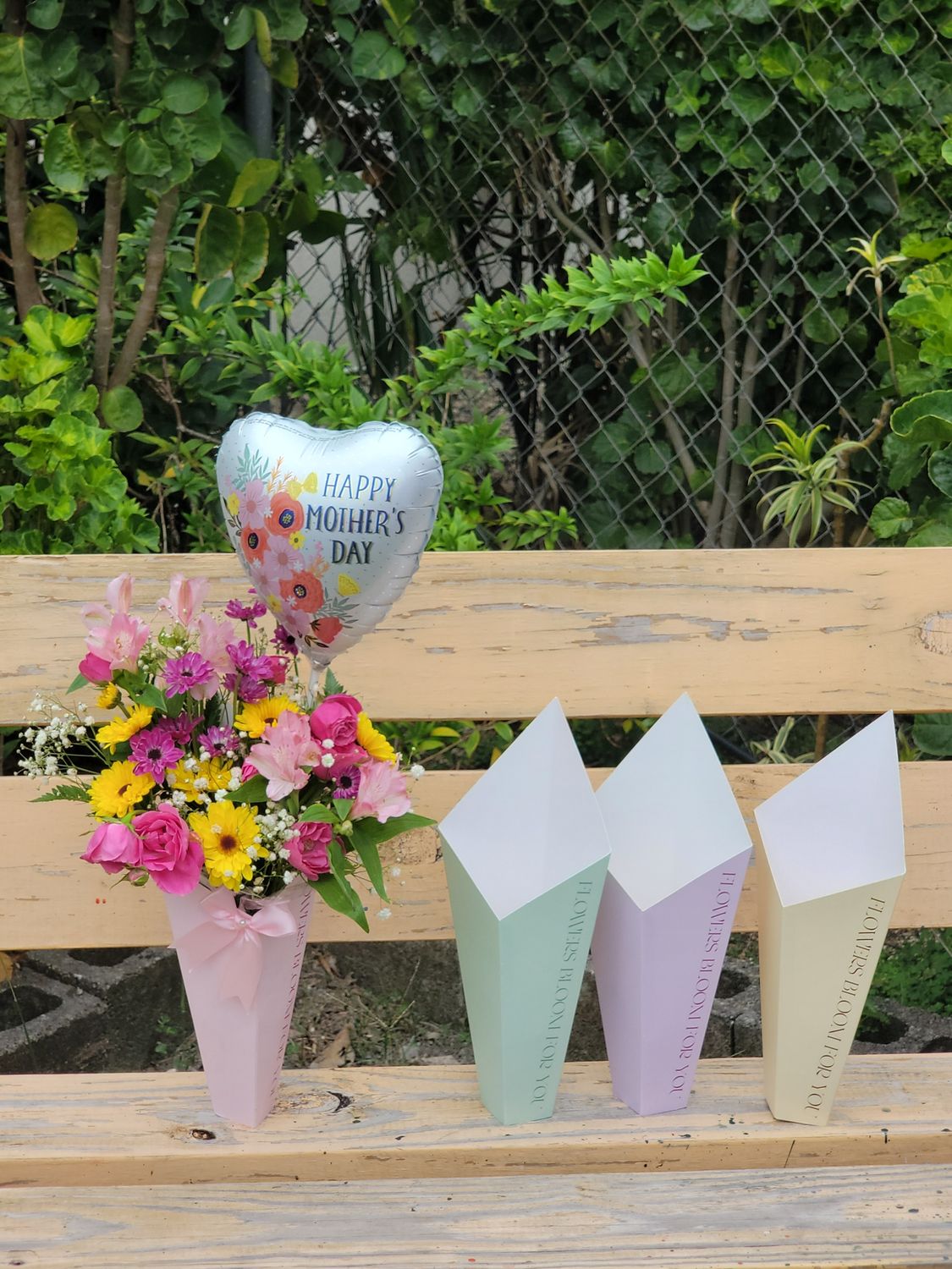 Cut flower in a box with a balloon
