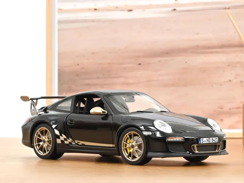 1:18 Norev - Porsche 911 GT3 RS 2009 Schwarz-Weiß-Gold metallic