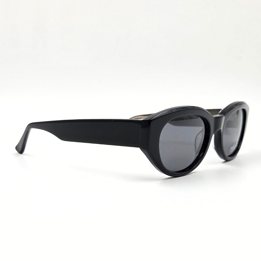 Moderne ovale Sonnenbrille schwarz mit dickem Rahmen und dunklen Gläsern – schräge Seitenansicht