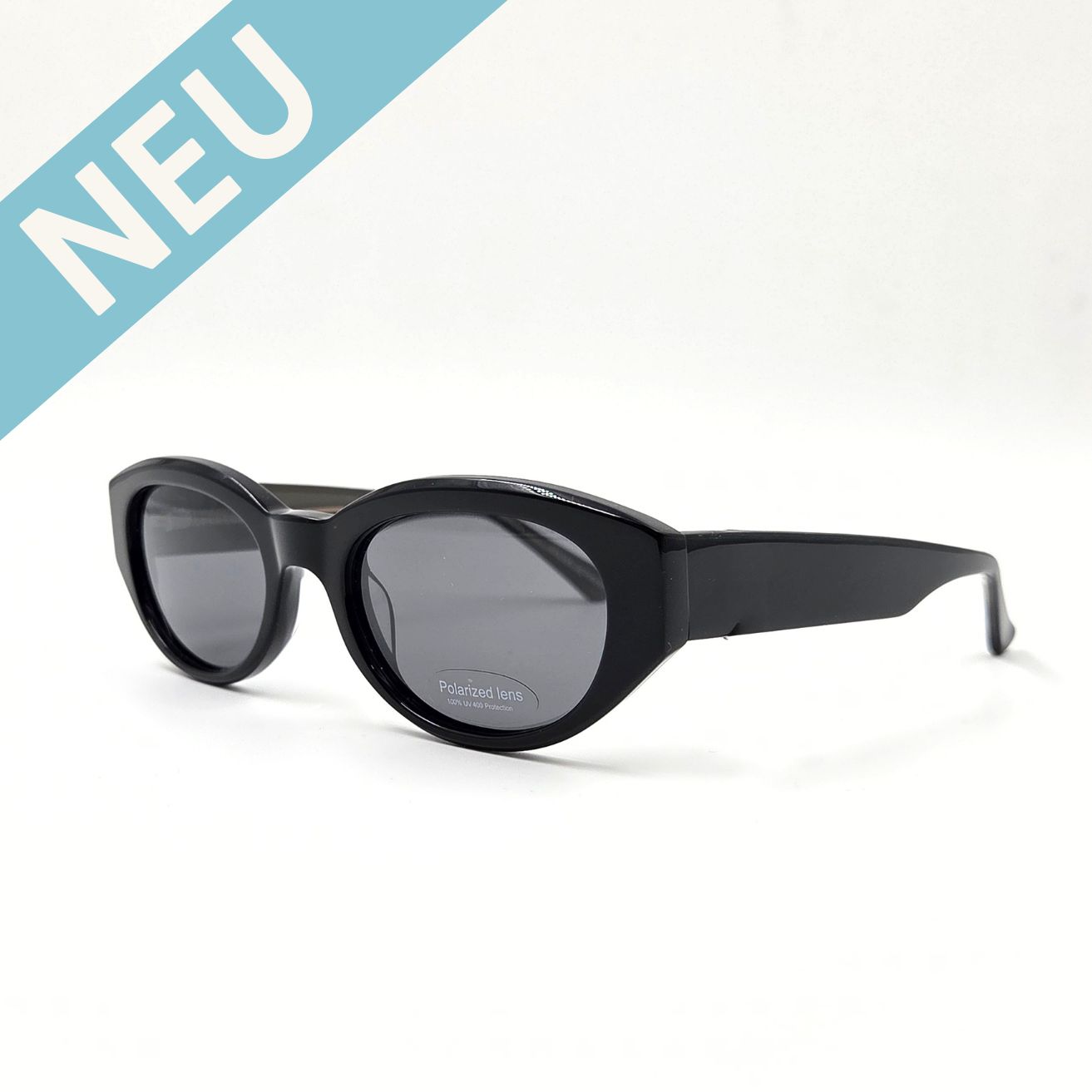 Moderne ovale Sonnenbrille schwarz mit dickem Rahmen und dunklen Gläsern – schräge Seitenansicht