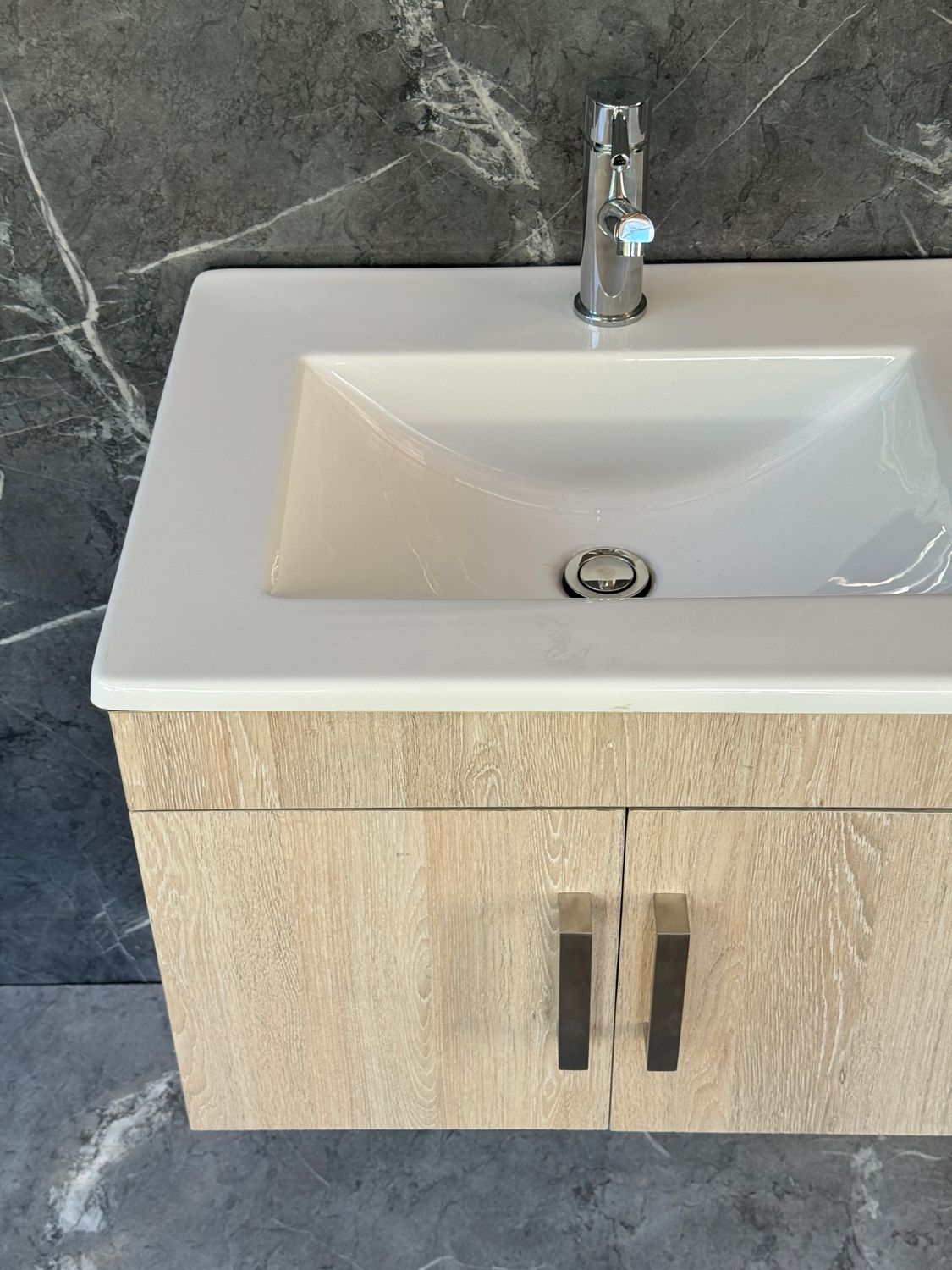 OASIS-600 Wall Mounted Cabinet &amp; Basin with silver handles.