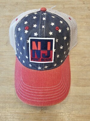 An Legacy brand American flag-inspired baseball hat with a red and blue patch that says NJ Point Beach sold at the Jenkinson&#39;s Boardwalk online store