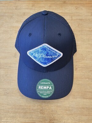 A navy-blue Legacy Rempa hat featuring an embroidered diamond-shaped &quot;Point Pleasant Beach&quot; patch on the front, displayed on a wooden surface sold through Jenkinson&#39;s Boardwalk&#39;s online store. 