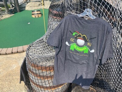 Dark grey t-shirt from Castaway Cove mini golf on Jenkinson&#39;s Boardwalk in Point Pleasant Beach. Back of shirt shown next to a hole at the miniature golf course. 