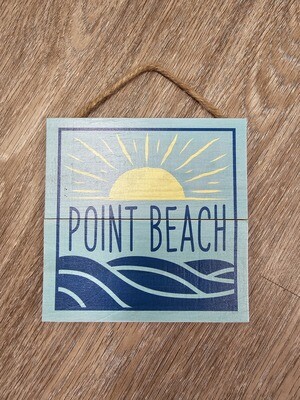 A light blue square wooden hanging sign with a yellow sun above the words Point Beach and dark blue waves below