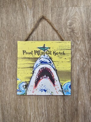 A square sign with a shark on a yellow background and the words Point Pleasant Beach
