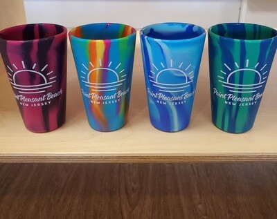 Four silicone pint glass by Silipint in berry, rainbow, blue and teal featuring a white sun design that says Point Pleasant Beach