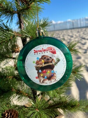 Jenkinson&#39;s Boardwalk/Jenkinson&#39;s Aquarium Christmas green holiday ornament featuring a drawing of a sloth wrapped in lights. 