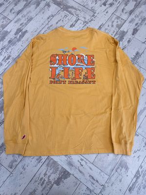 The back of a long sleeve yellowish orange shirt that says Shore Life and Point Pleasant