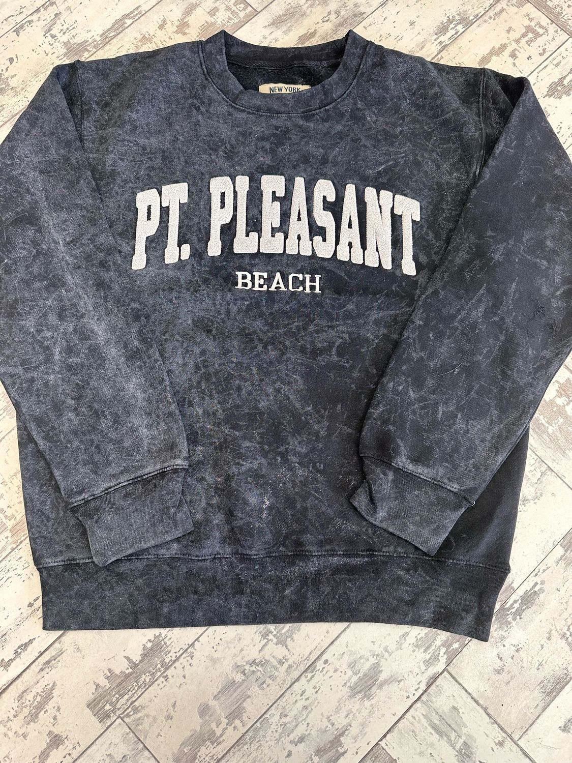 Acid wash-style Point Pleasant Beach sweatshirt with white lettering sold by Jenkinson&#39;s Boardwalk through its online store