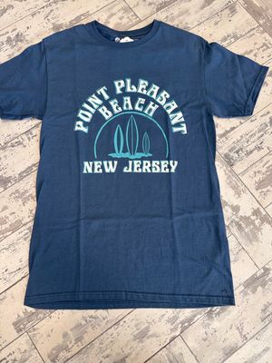 A navy blue t-shirt with a turquoise retro-style print reading &quot;Point Pleasant Beach, New Jersey&quot; and an arch design with three surfboards in the center