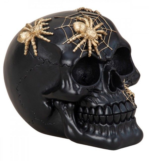 Zwarte schedel met gouden spinnen