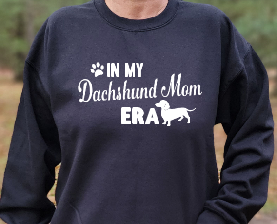 In my Dachshund Mom Era Unisex Tshirt or Sweatshirt with DHACR logo on back