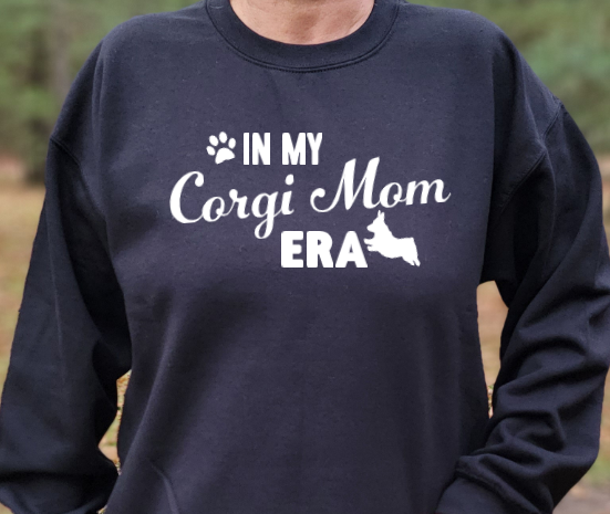 In my Corgi Mom Era Unisex Tshirt or crewneck Sweatshirt with DHACR logo on back