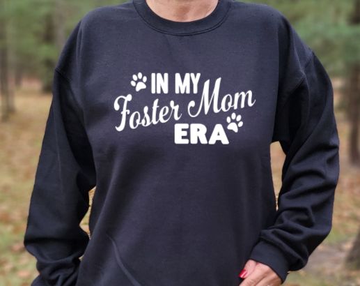 In my Foster Mom Era Unisex tshirt or crewneck sweatshirt with option for ARAR Logo on back