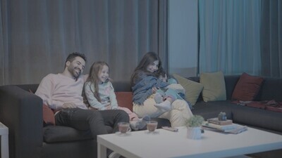 a family of four watching television