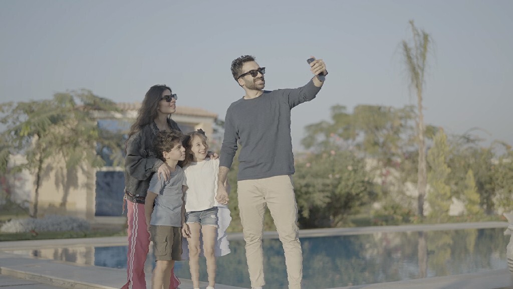 a family of four taking a selfie in the garden