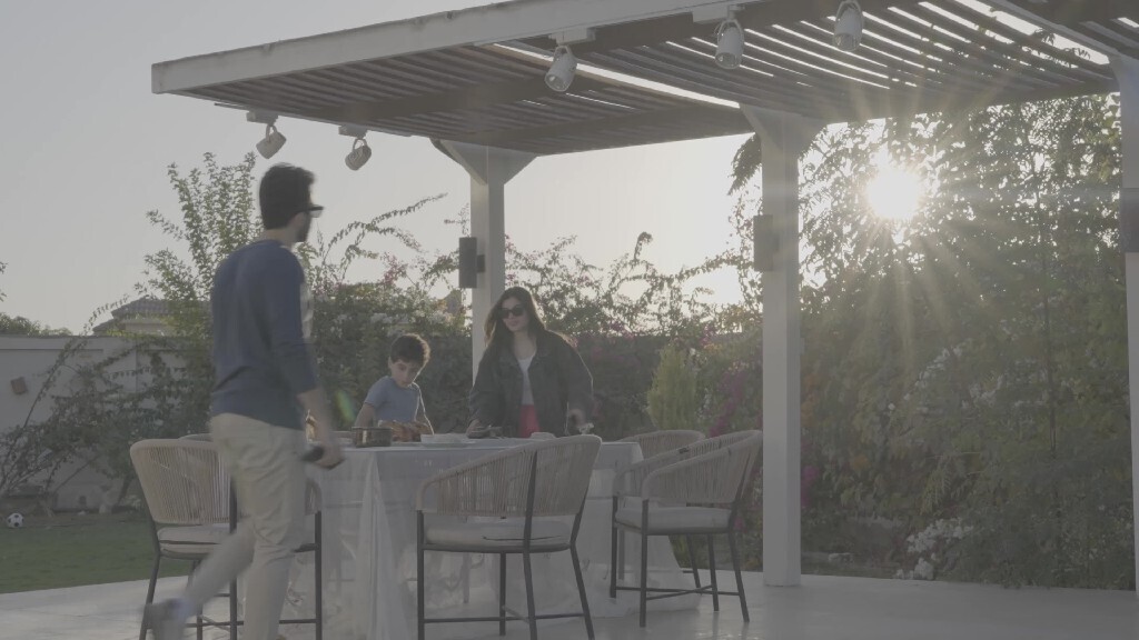 a family preparing a dining table in the garden