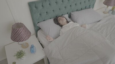 a woman sitting in bed waking up