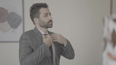 a man standing in front of a mirror wearing a jacket
