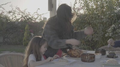 a family preparing a dining table in the garden