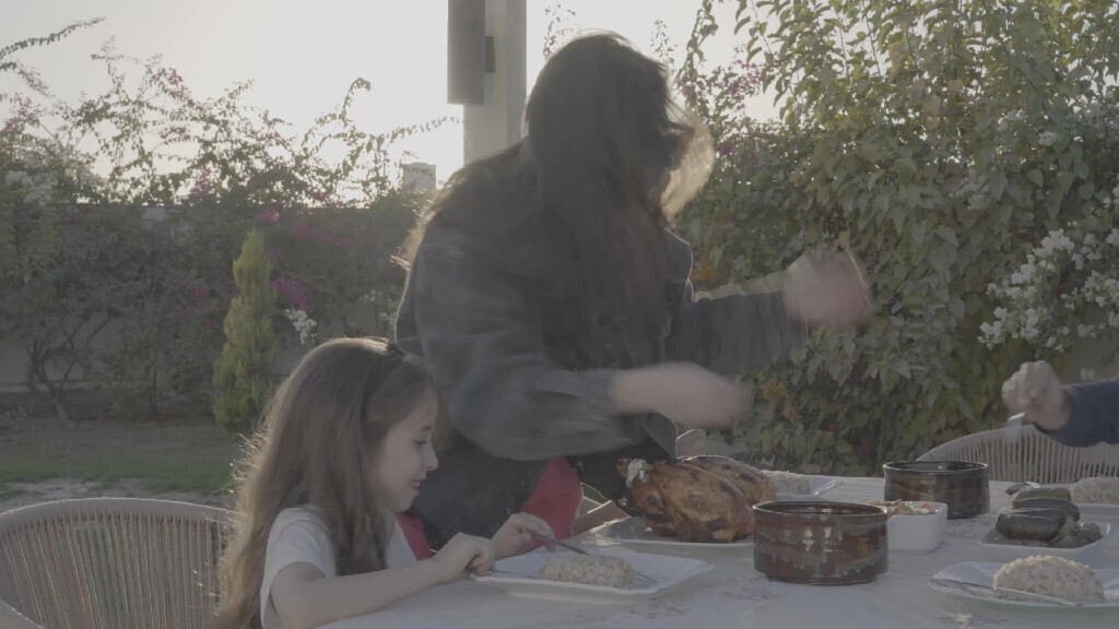 a family preparing a dining table in the garden