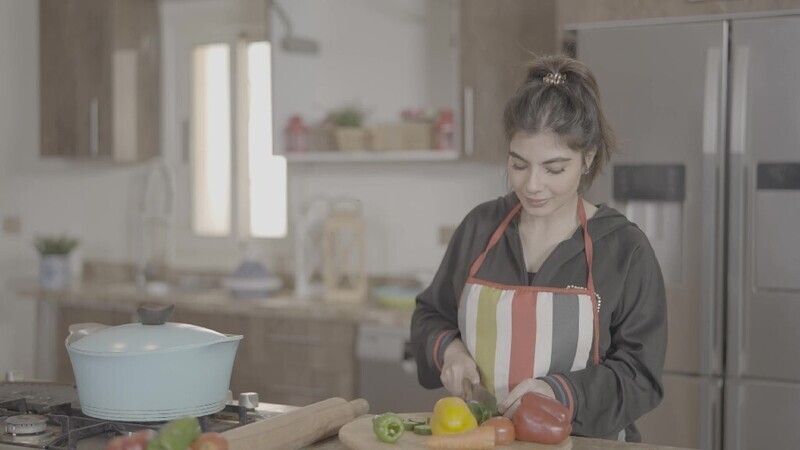 a woman cooking in the kitchen