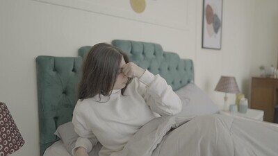 امراة تجلس على السرير تستيقظ 