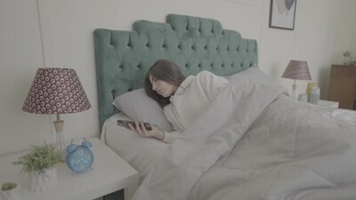 a woman sitting in bed waking up