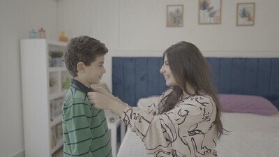 a mother dressed her child in bed