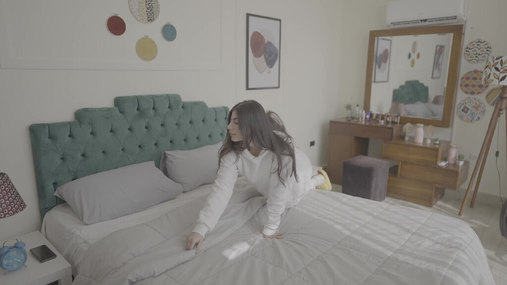 a woman prepared the bed after she woke