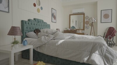 a woman sitting in bed waking up